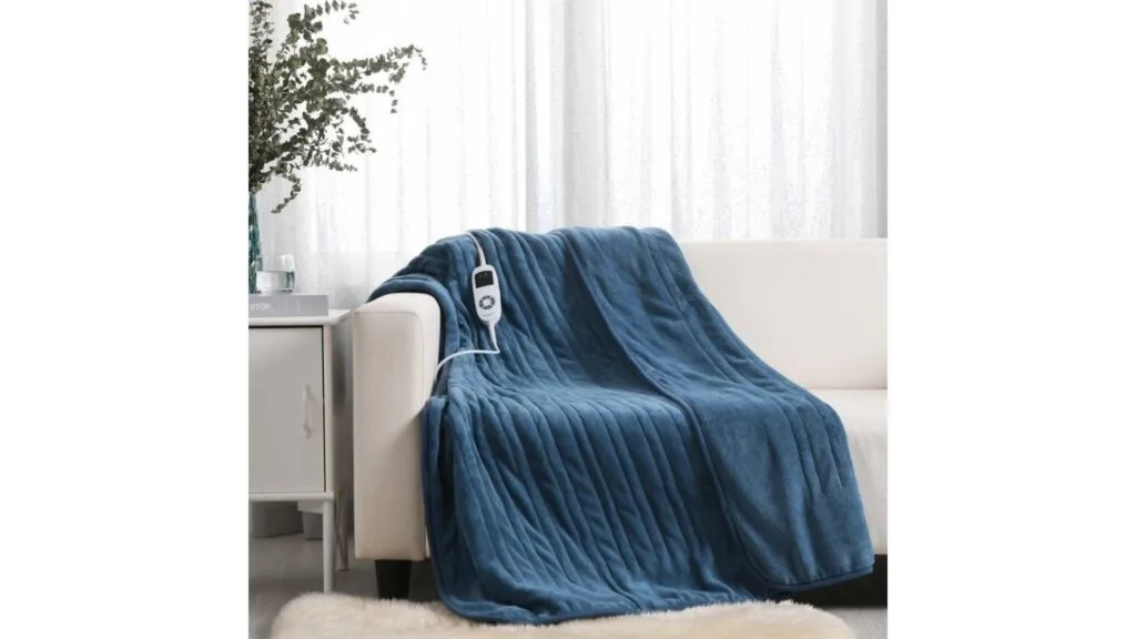 A blue electric throw blanket on a white couch.