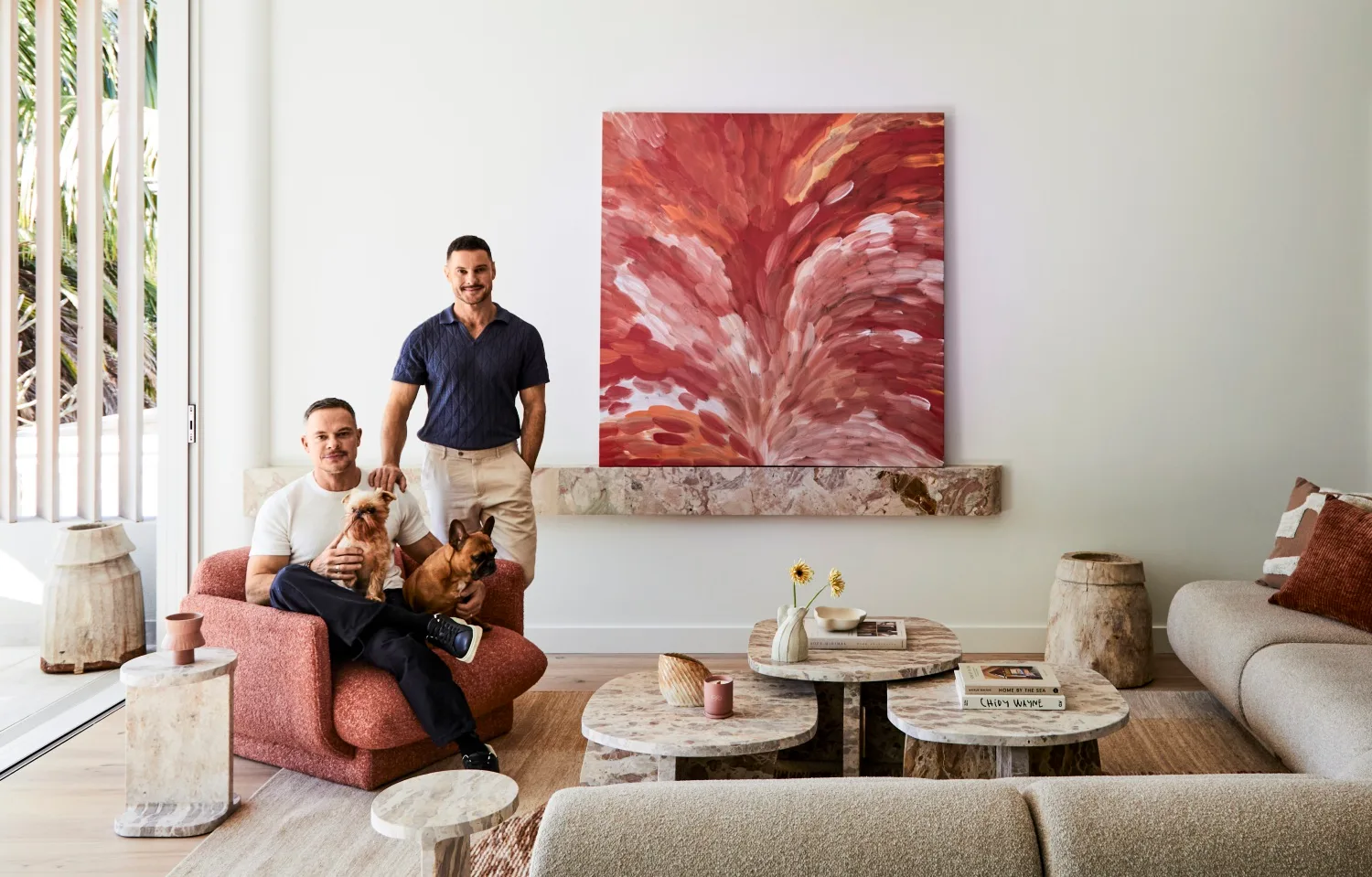 Darren Palmer with Olivier Duvillard and their dogs in the living room.