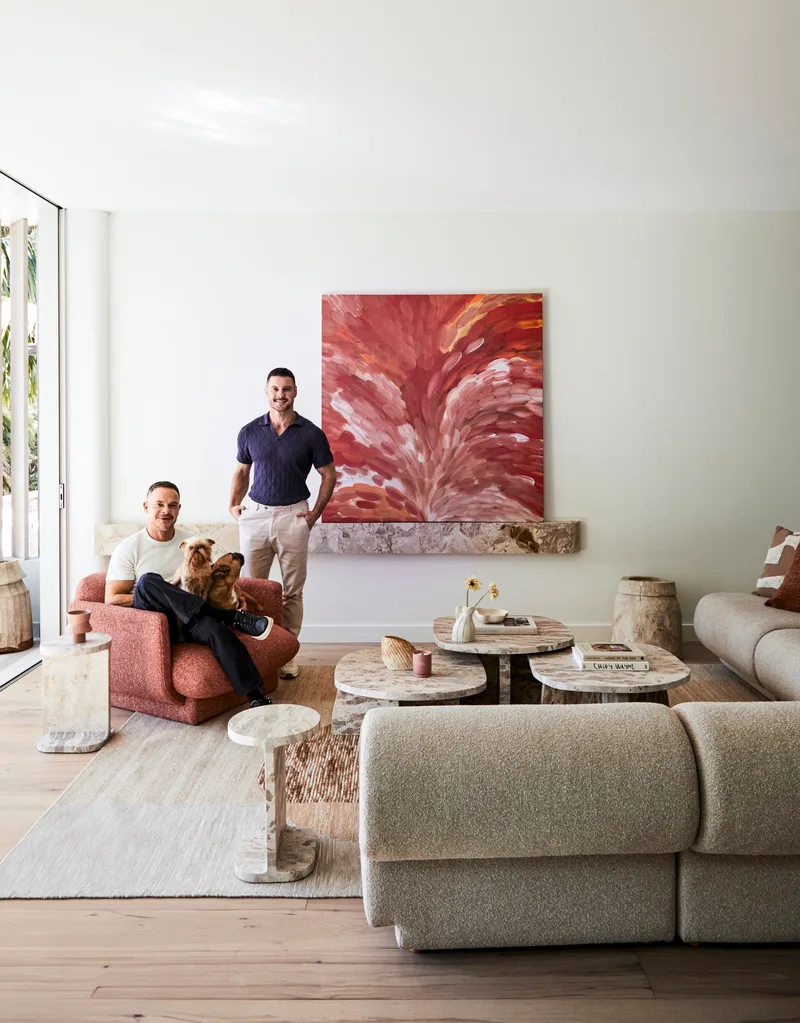 Darren Palmer with Olivier Duvillard and their dogs in the living room.