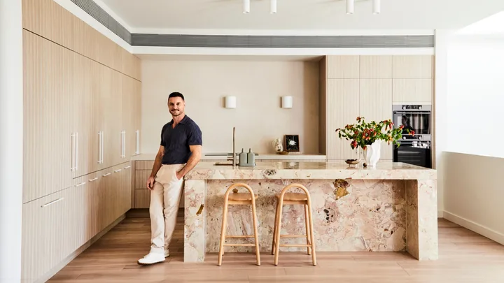 Darren Palmer's kitchen with Darren standing next to the bench