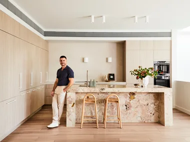 Darren Palmer's kitchen with Darren standing next to the bench