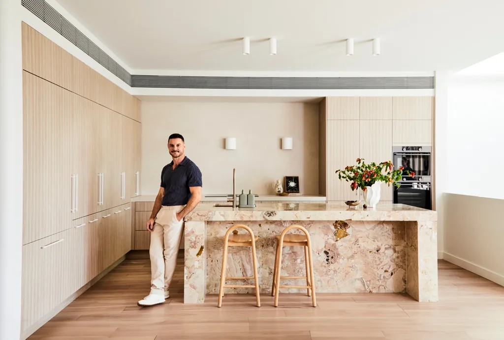 Darren Palmer's kitchen with Darren standing next to the bench