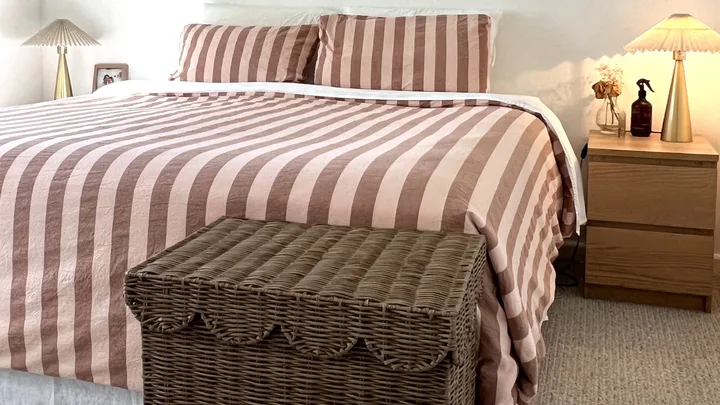 Most aesthetic laundry basket against bed