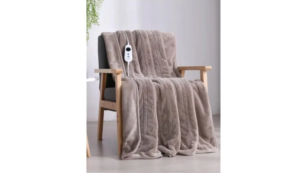 A light brown electric throw blanket draped over a timber and grey upholstered chair.