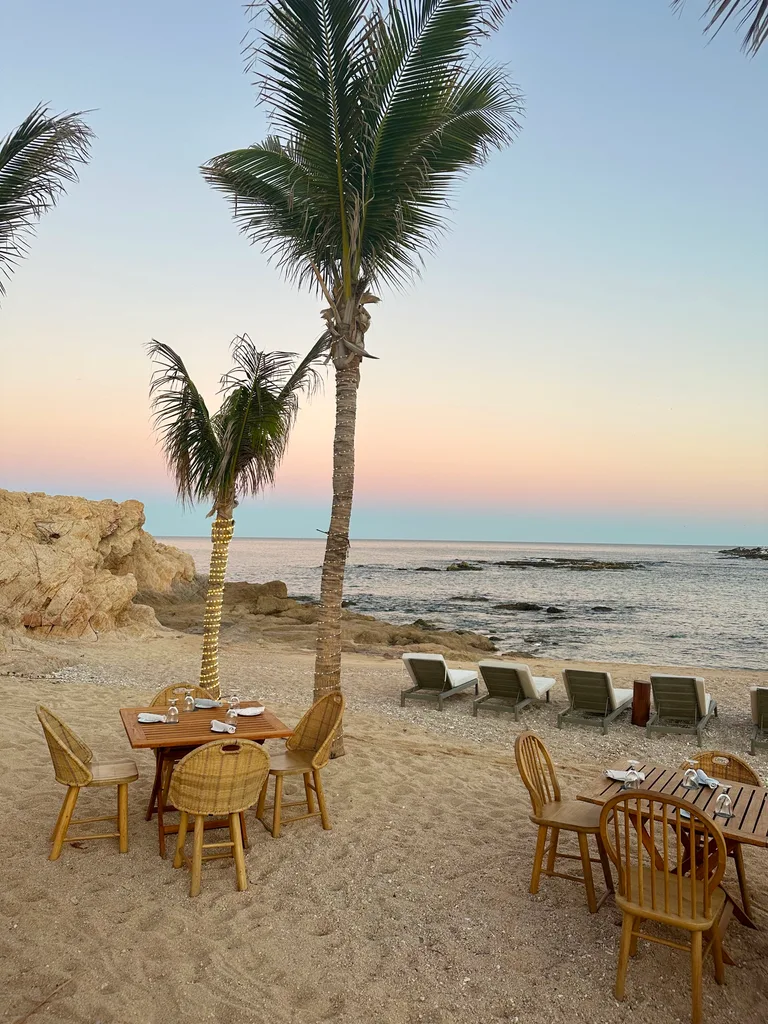 A beach-side bar in Los Cabos with loungers and tables.
