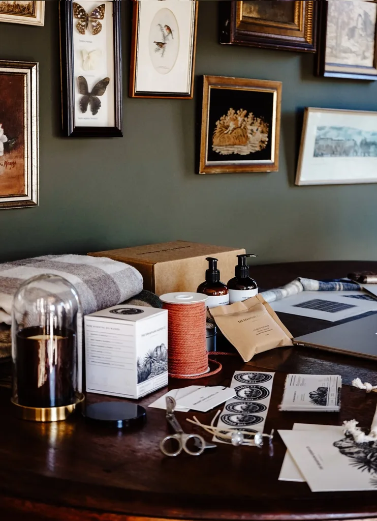 A timber table with Grampians Goods Co. candles and blankets.