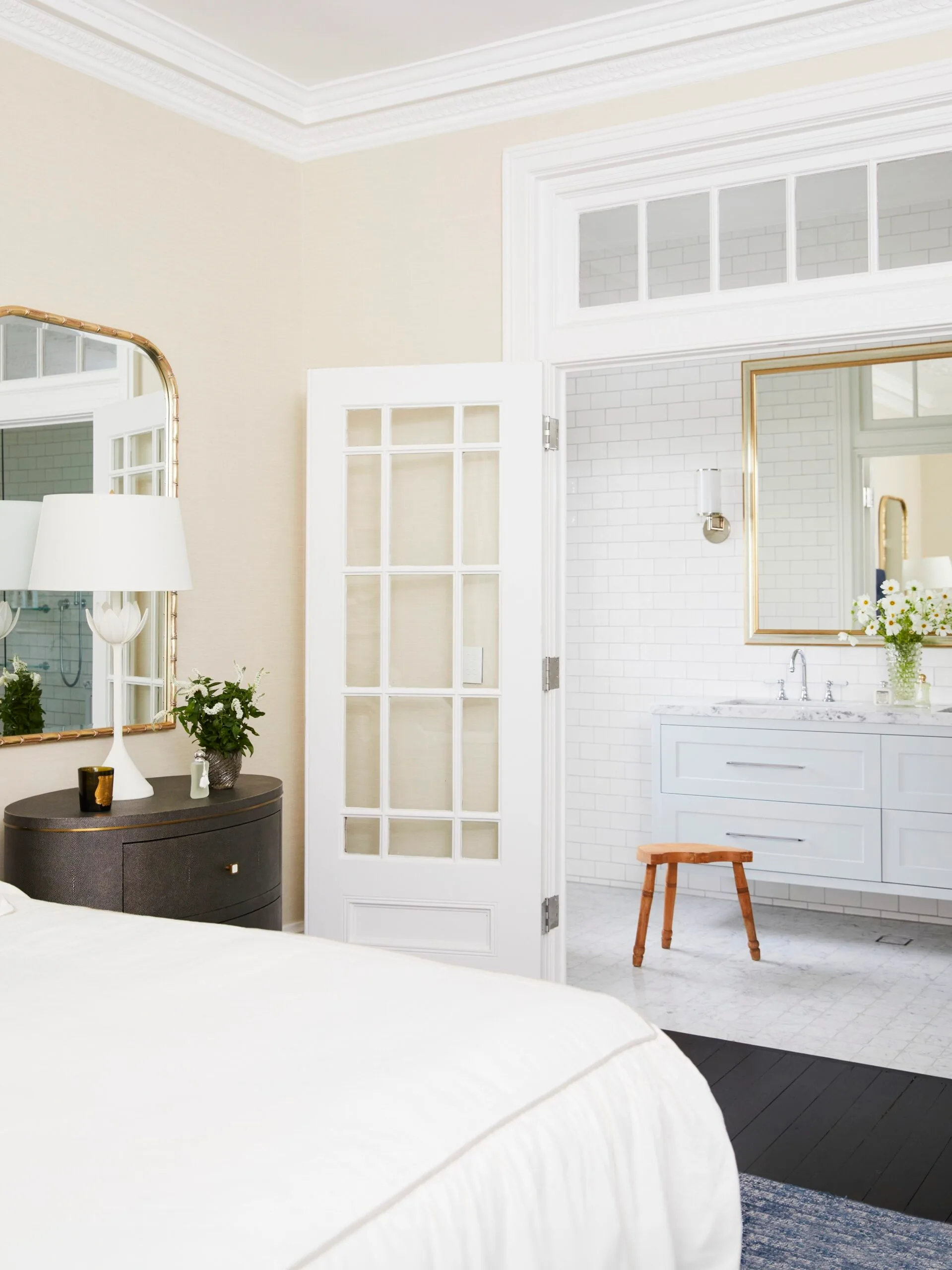 A classic white main bedroom and ensuite with French-style doors.