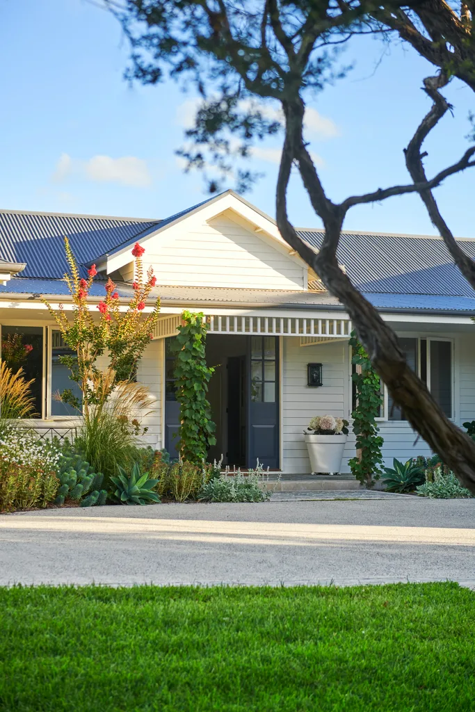 The cladded facade of a blue and white holiday home.