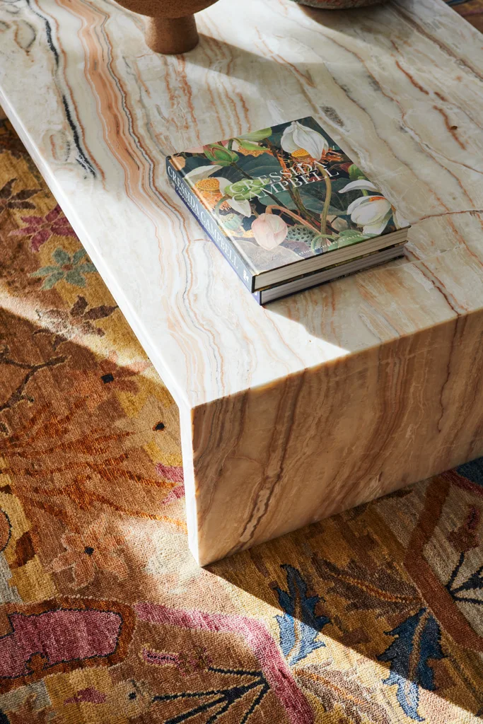 A marble-look table above a patterned rug.