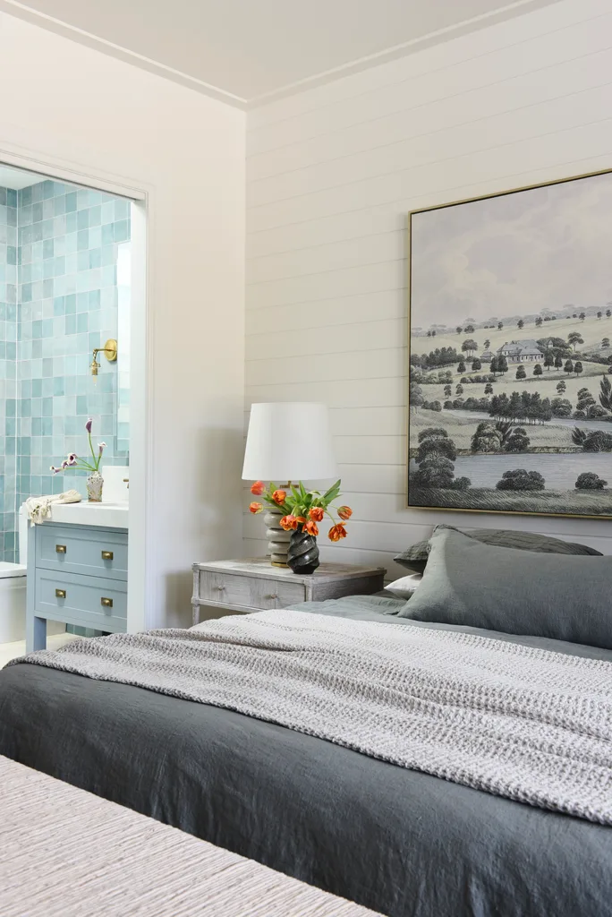 A secondary bedroom and ensuite elegantly styled in blue and grey.