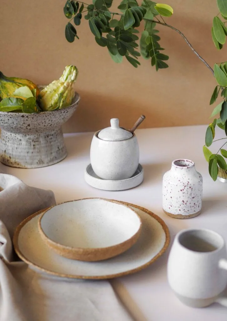 A collection of white handmade ceramic tableware.