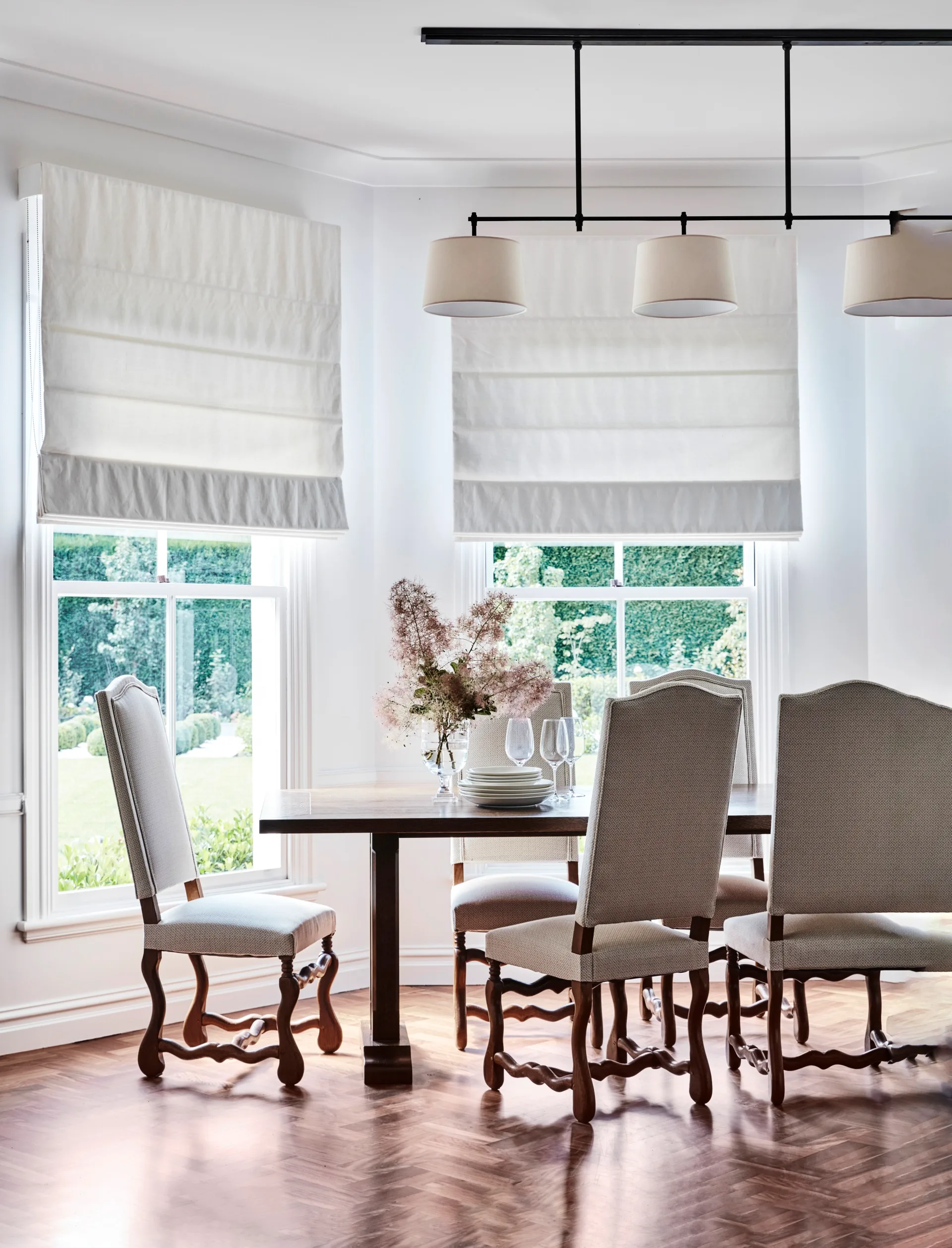 A classic country dining room with a vintage dining table and chairs.