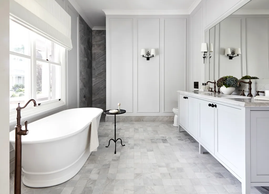 A classic country-style ensuite with a freestanding bath and wainscoting.