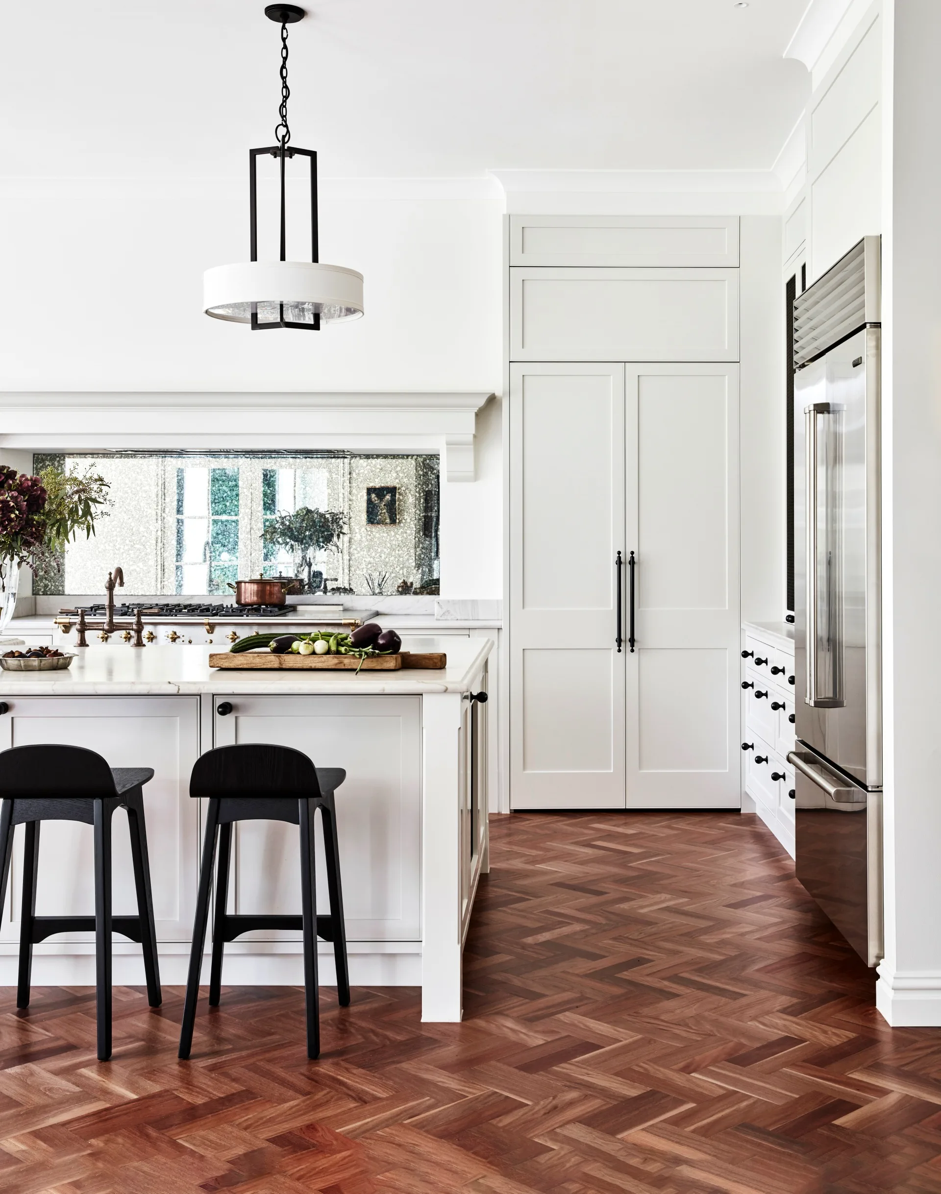 A classic country kitchen with shaker-style cabinets and parquet flooring.