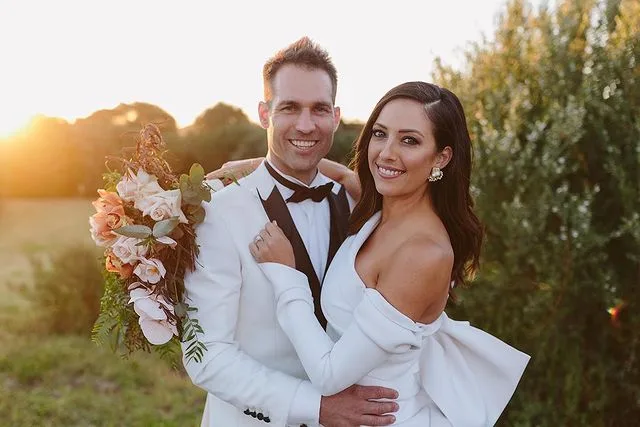 Dan and Dani from The Block on their wedding day, hugging and smiling.