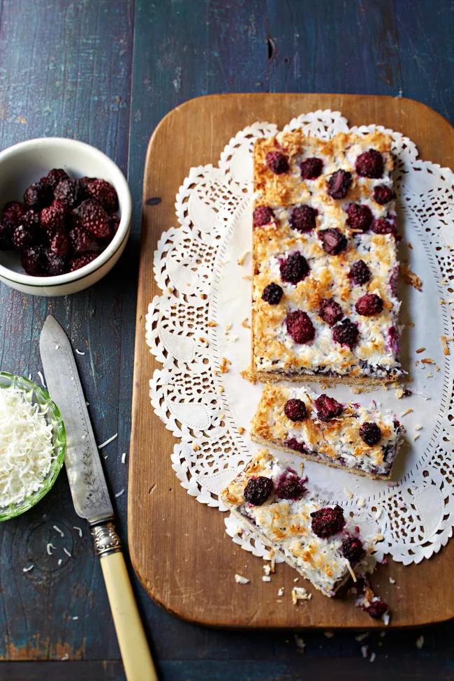 Gluten free coconut and berry slice on a doily
