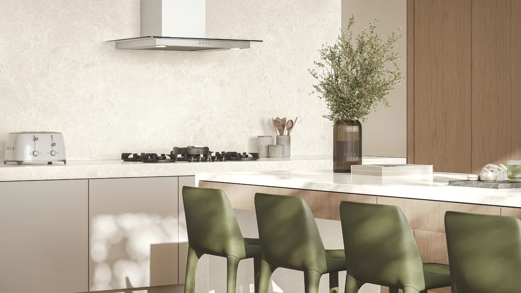 A white kitchen with green chairs and plants