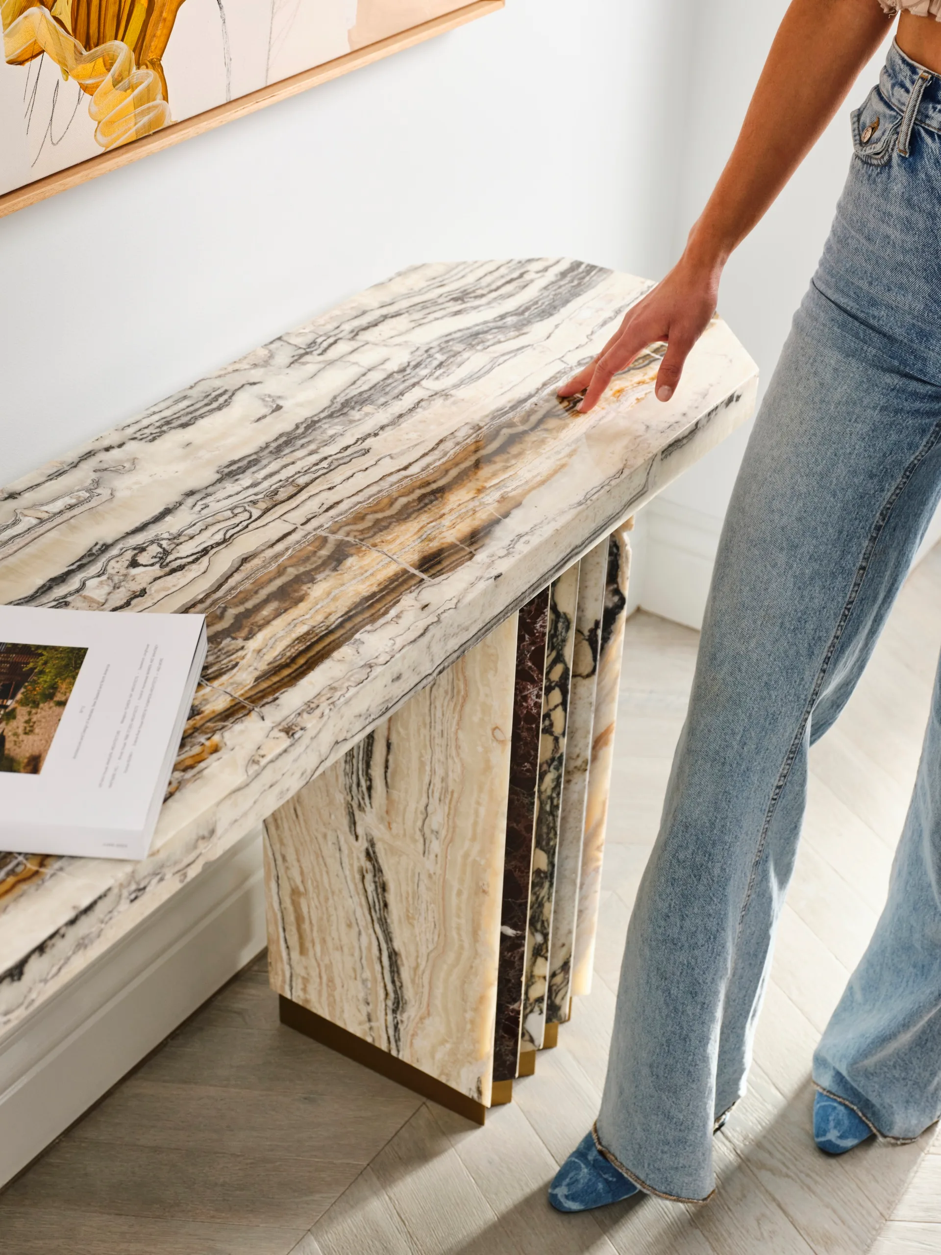 Marble console table with a coffee table book on top.