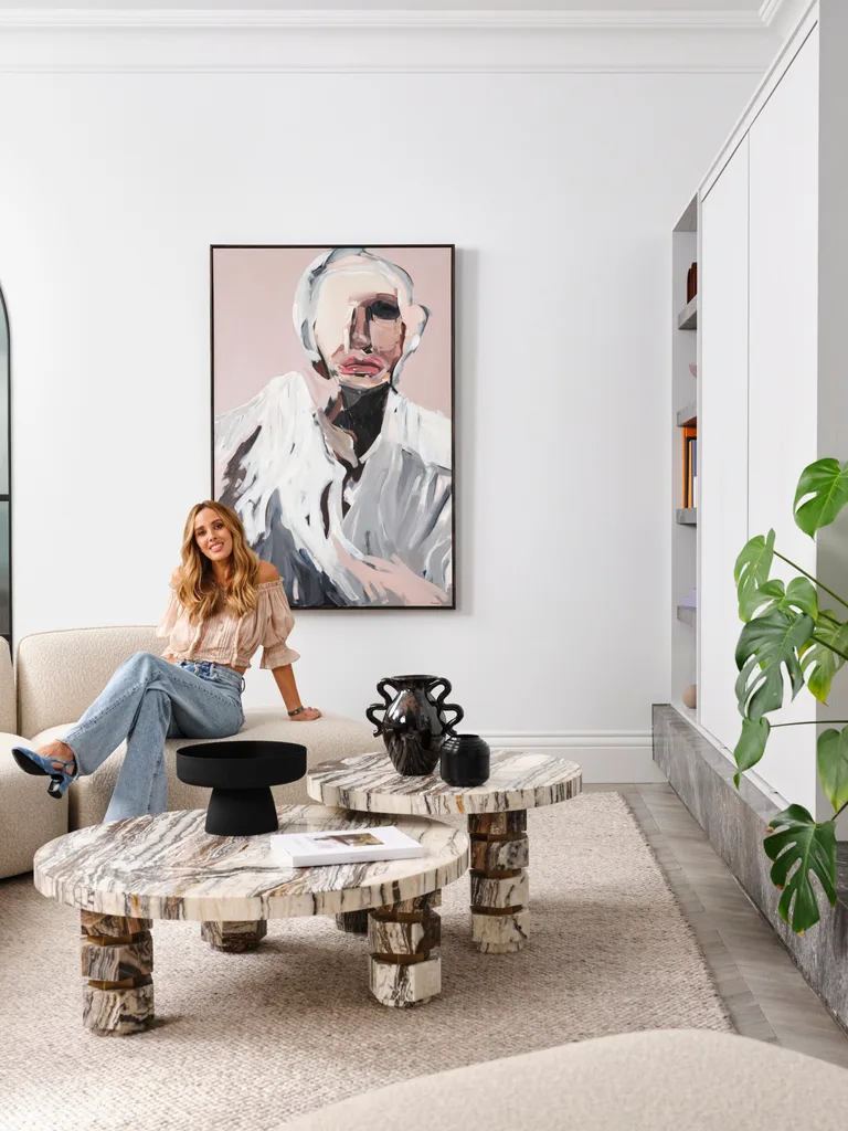Bec Judd sits in her living room, beside the Tiramisu marble coffee table she created with Trit House.