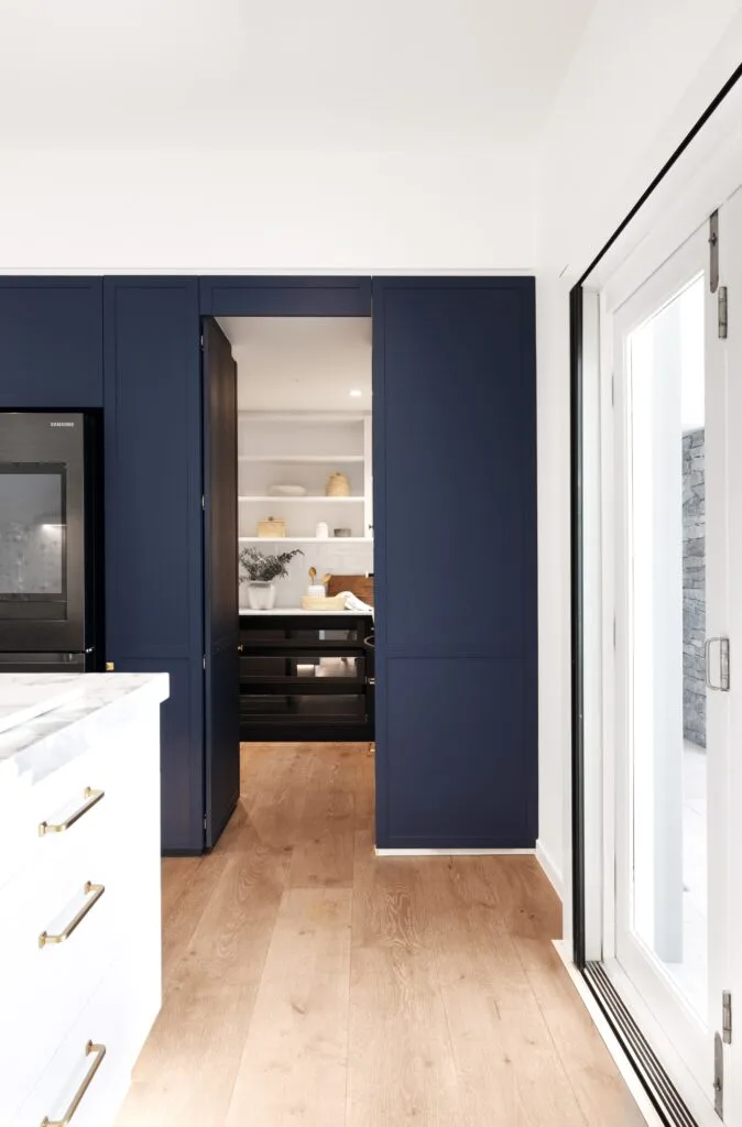 A modern country kitchen leading into a butler's pantry.