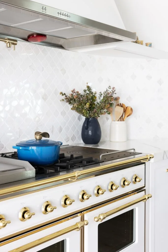 Dual white and gold Ilve ovens.