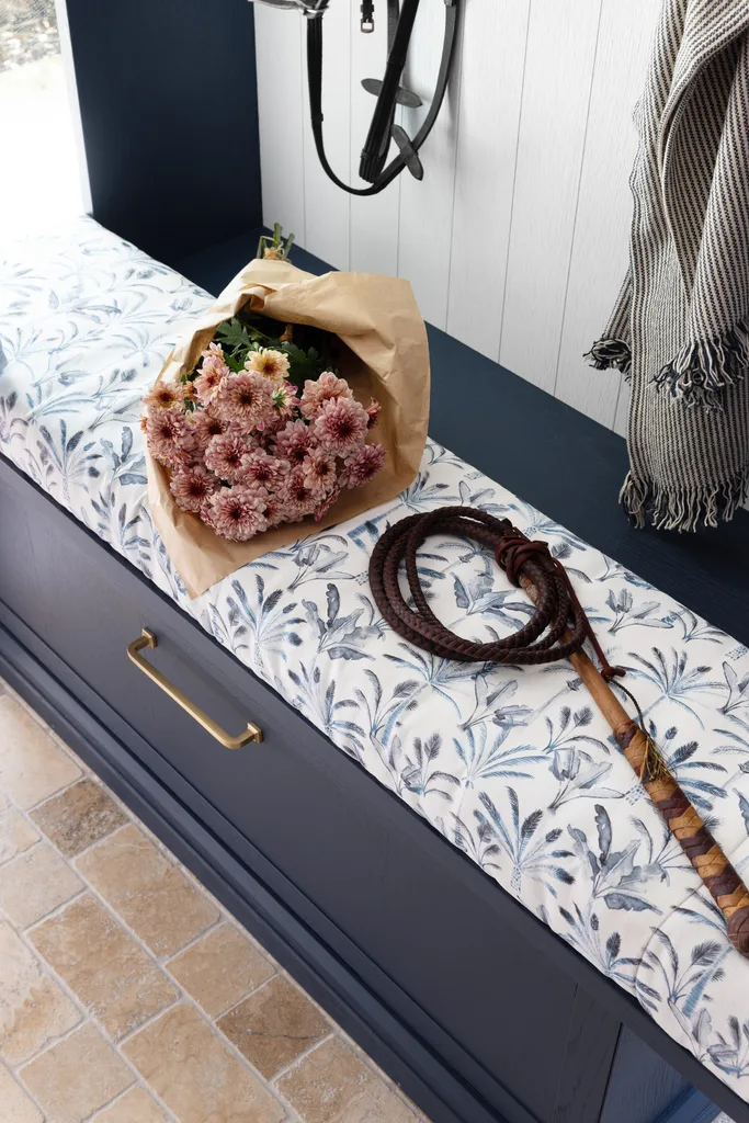 A blue leaf fabric mudroom bench.