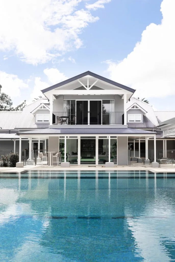 A two-storey modern country home beside a pool.