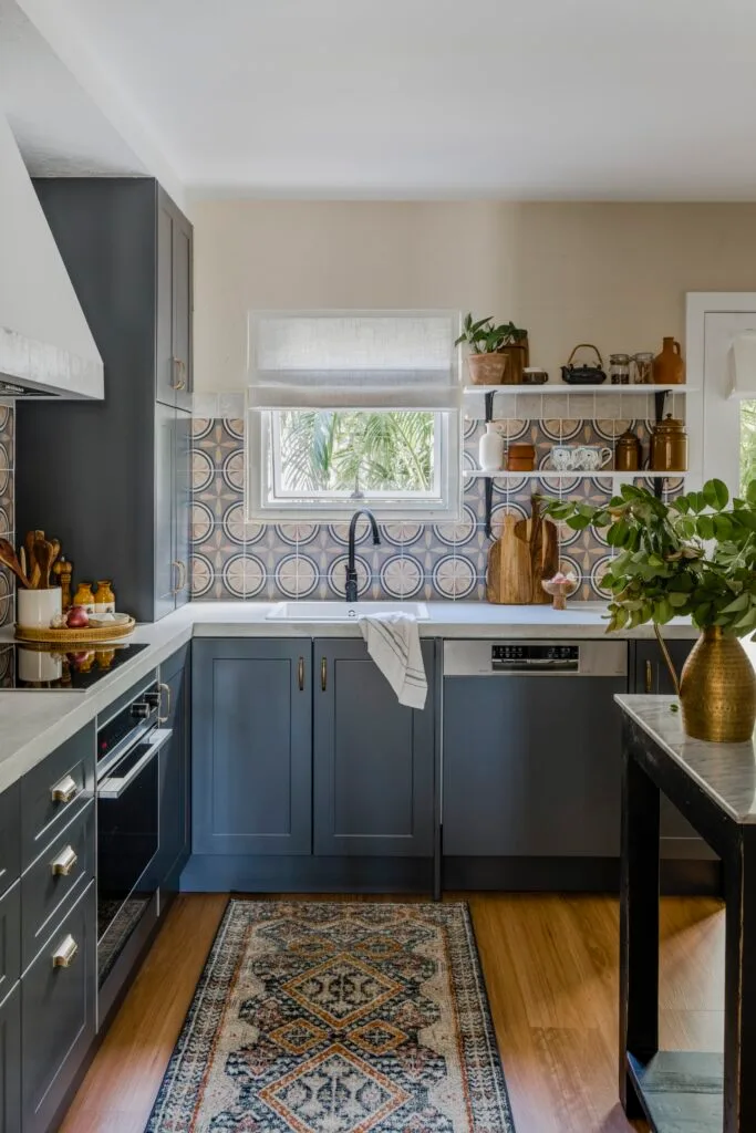 An antique-style rug runner on a wooden kitchen floor.