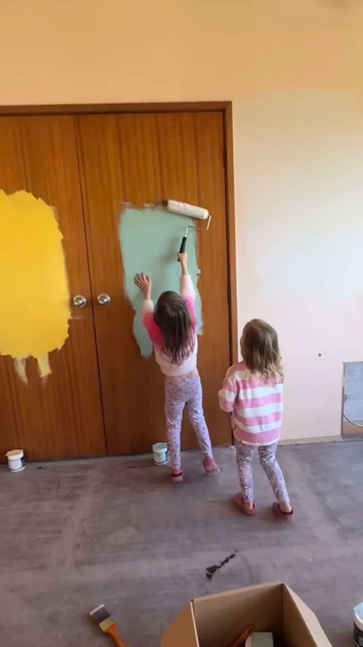 Laura and Matty J's children testing paint colours on the cupboard doors. 