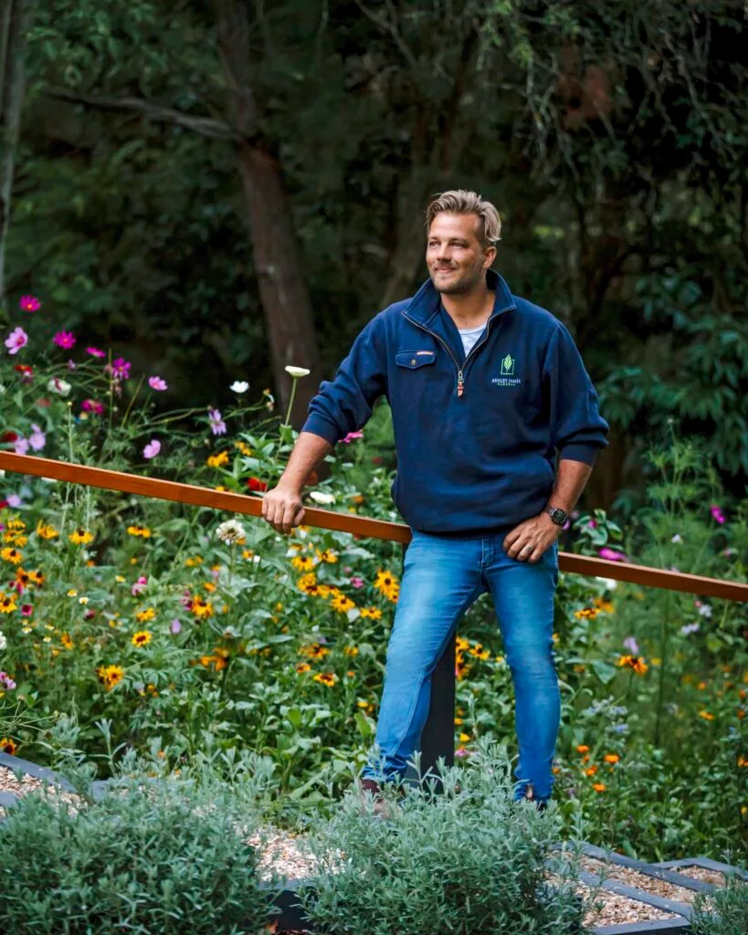 Gardener Ashley James standing near wildflowers.