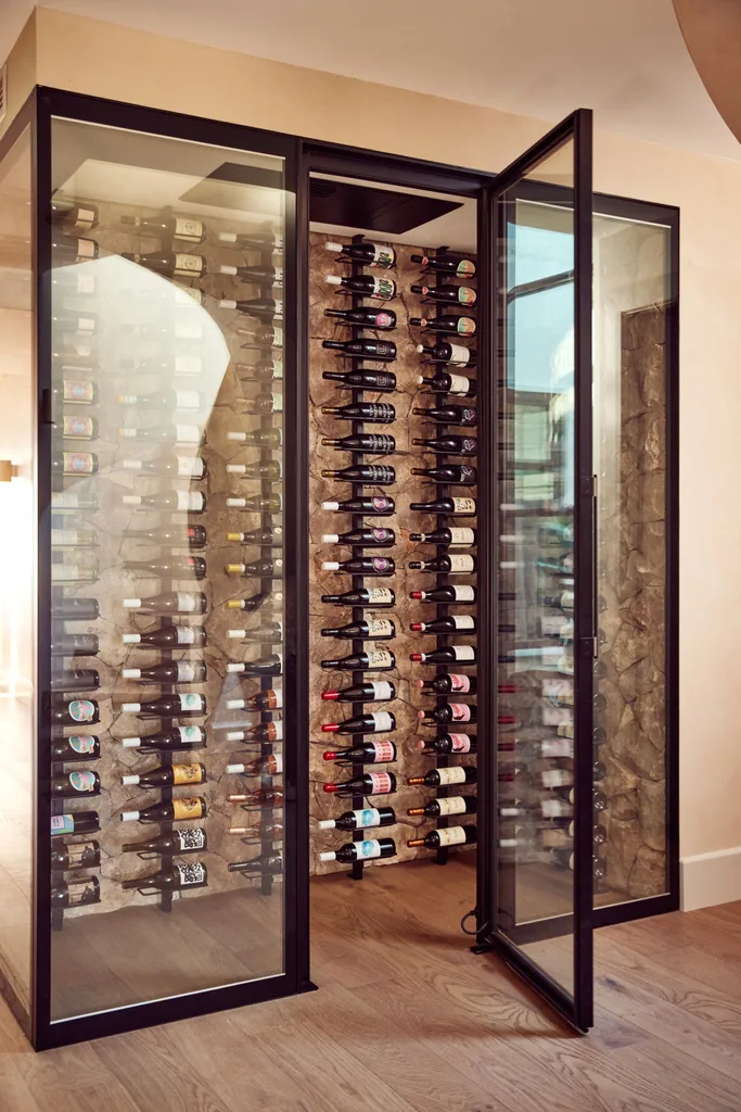 A glass walled cellar with wines.