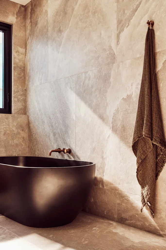 A spacious main bathroom with a freestanding stone bath.