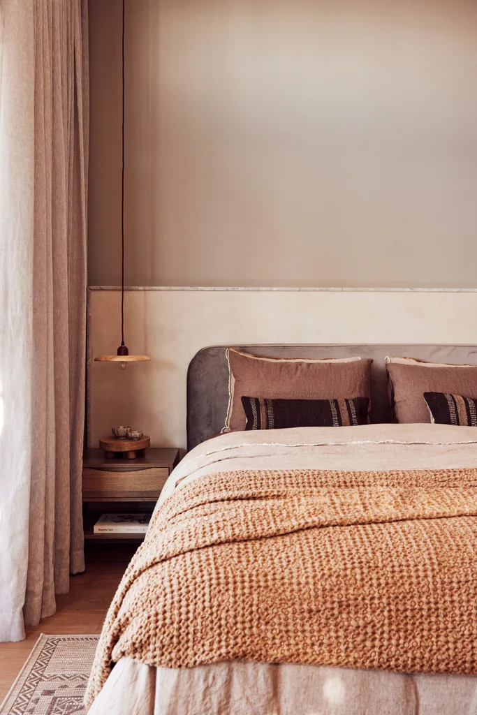 A Spanish resort style bedroom with natural linens.