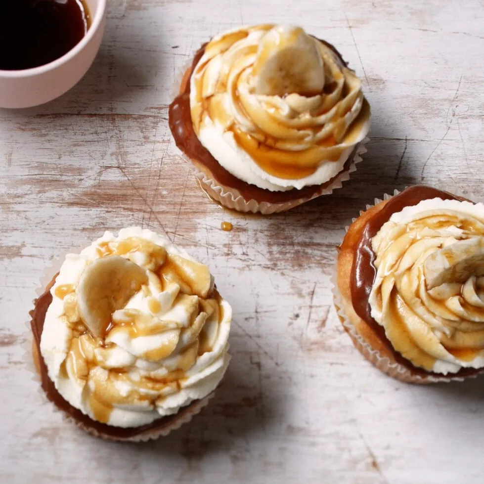 Banoffee pie cupcakes on a board with toffee sauce