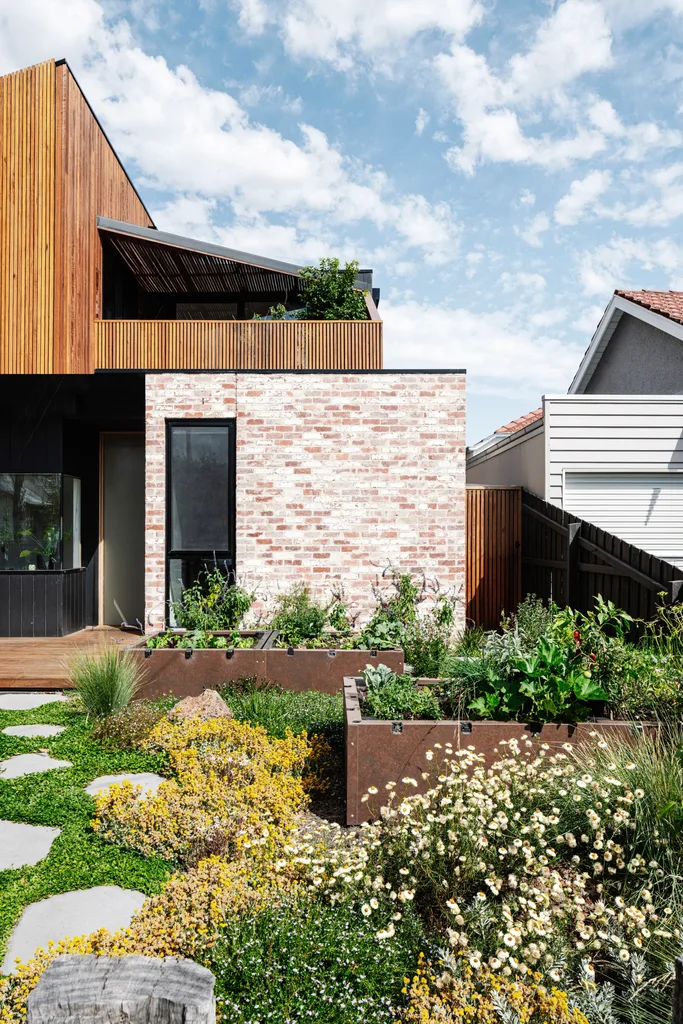 Seasonal produce grows in garden beds, clad in corten steel.