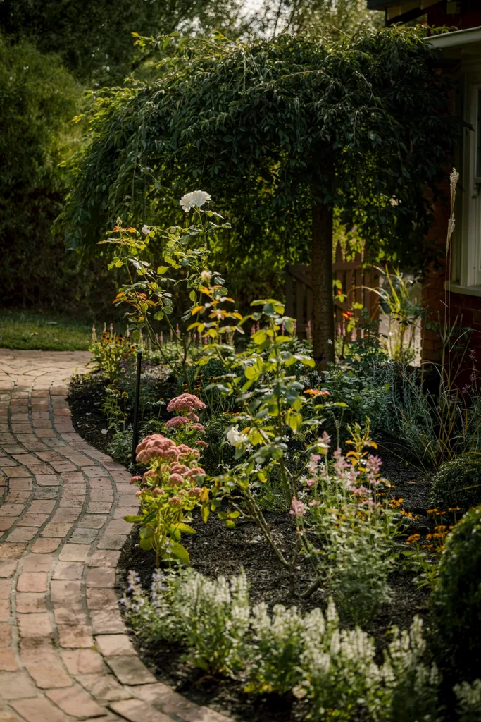 A brick path makes a border for plants.