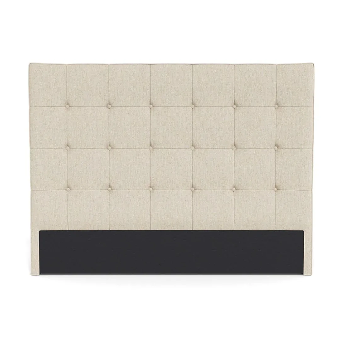 A beige tufted bedhead. 