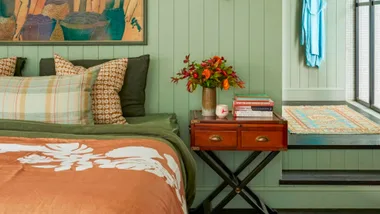 Feng shui tips in a bedroom with bed positioned against wall