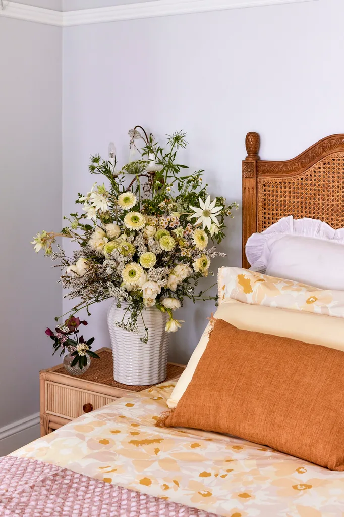 This bedroom is filled with woven items, from the rattan bedhead to the braided bedside table.