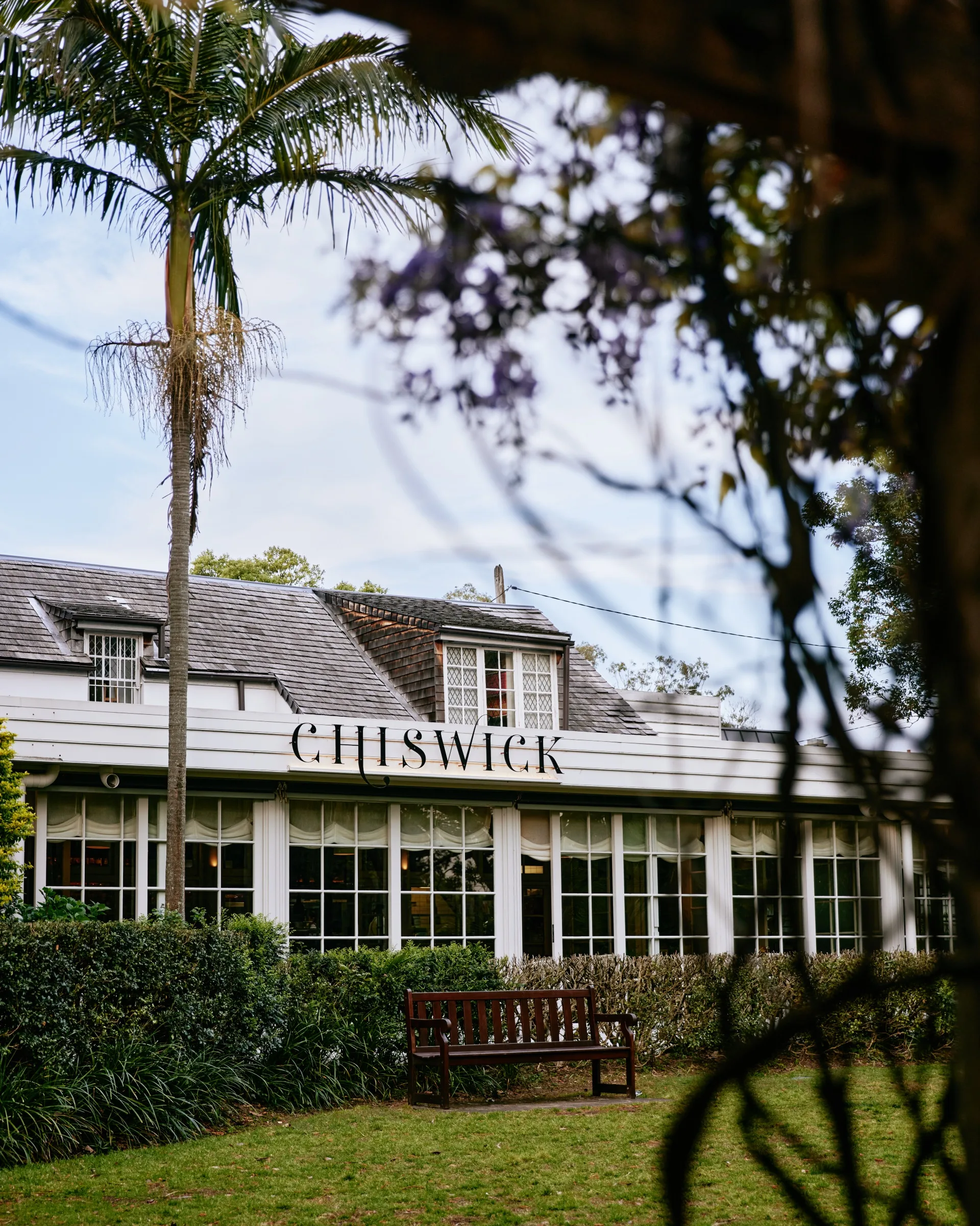 Chiswick restaurant has a beautiful garden growing around the white building 