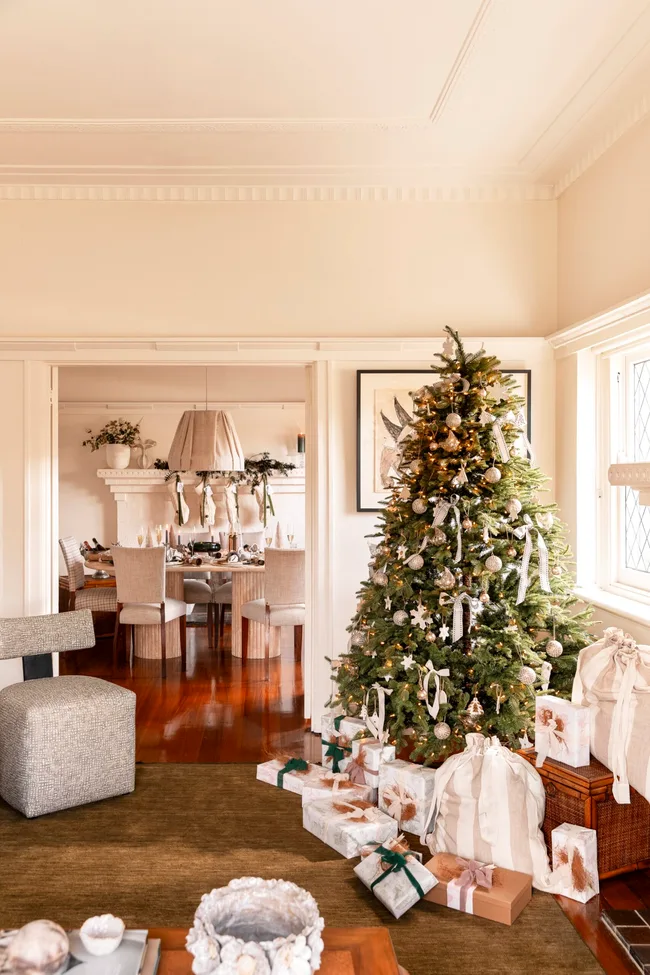 Neutral decorations and pops of green enhance the appeal of this Christmas tree