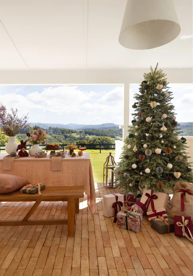 A christmas tree in an alfresco dining area with stunning views of green fields and rolling hills