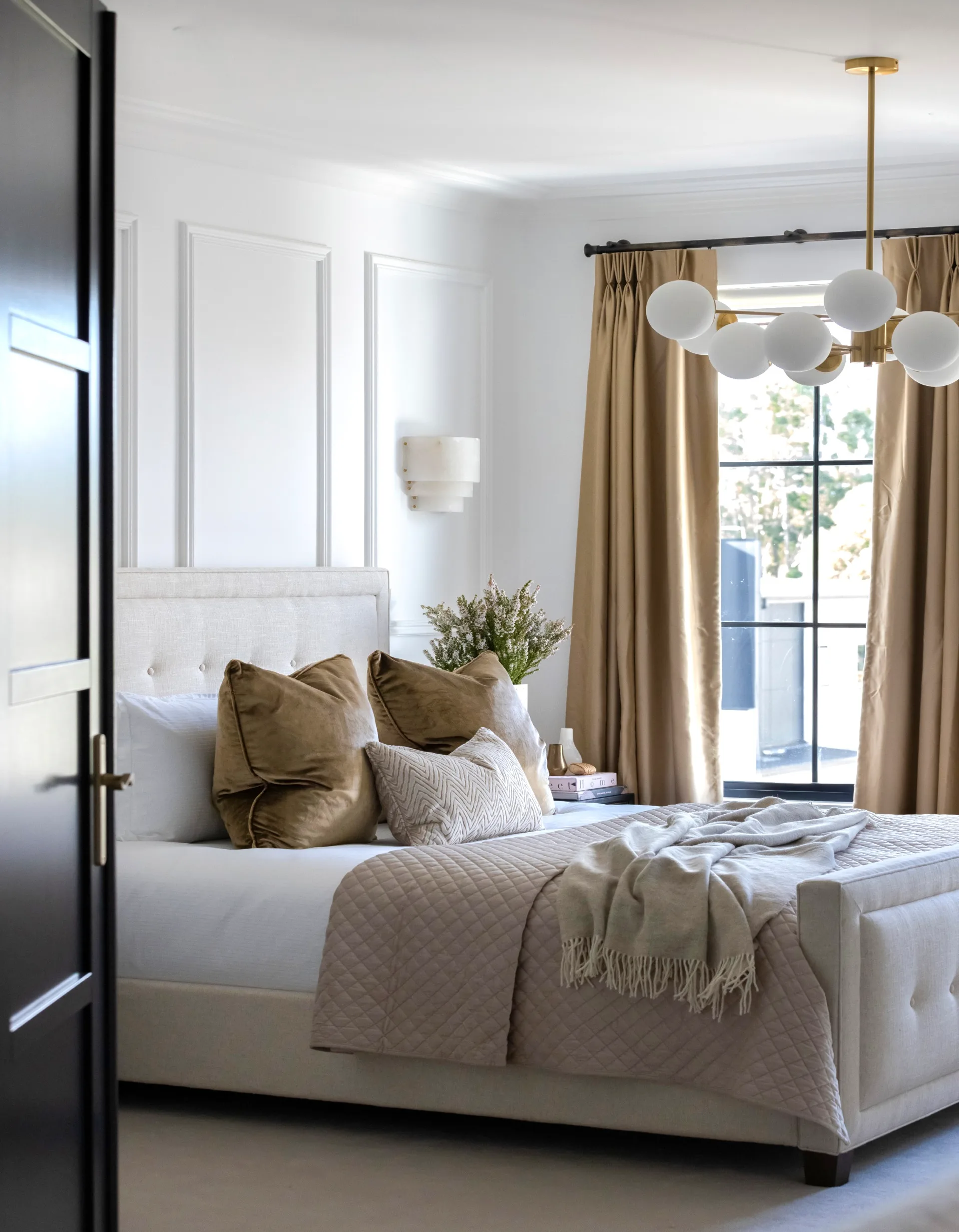 Coco Republic Interior Design Masterclass bedroom with brass domed pendant light and wall sconce with gold silk curtains