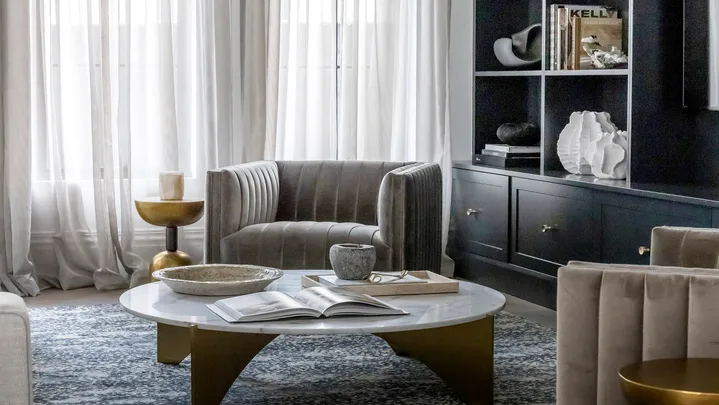 Coco Republic Interior Design Masterclass living room armchair with statement modern chandelier custom bookshelves and sheer curtains