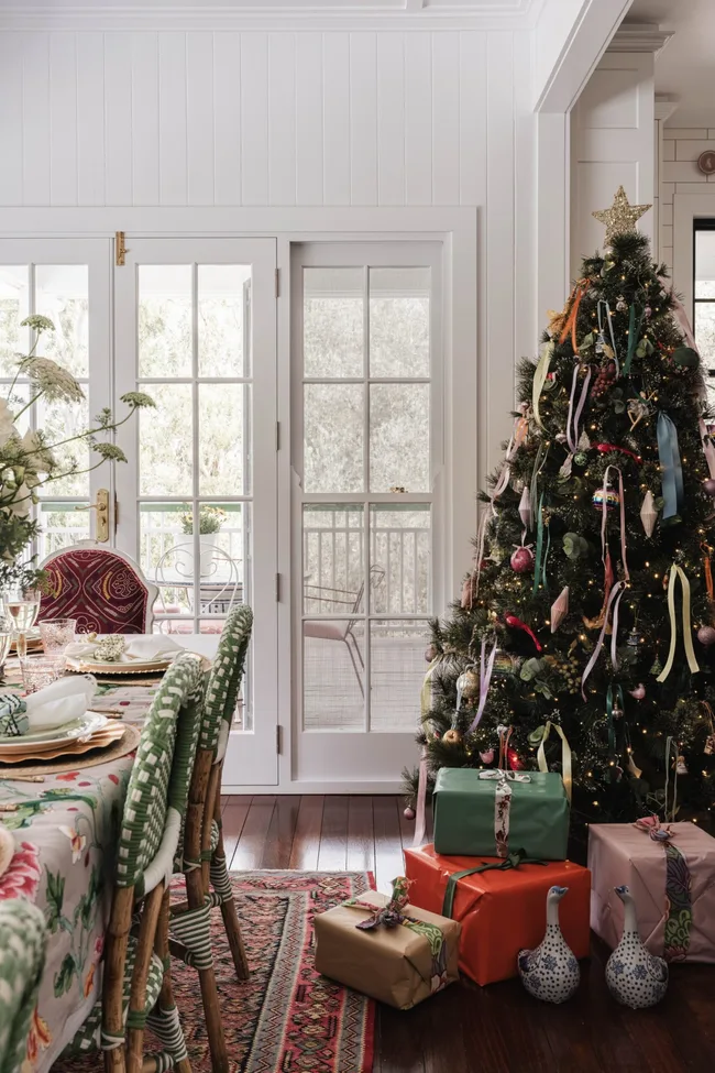 Colourful ribbons provide brightness and joy in this Christmas tree, alongside grounding warm white lights