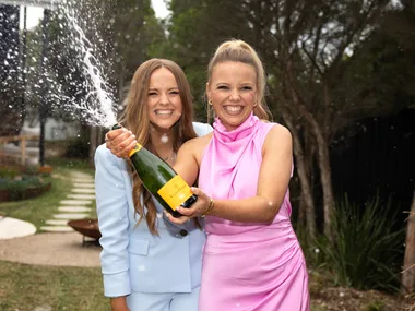 The Block 2024 winners Maddy and Charlotte Popping Champagne