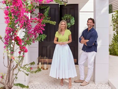 Tim and Anna Robards outside their home with bougainvillea framing the entry
