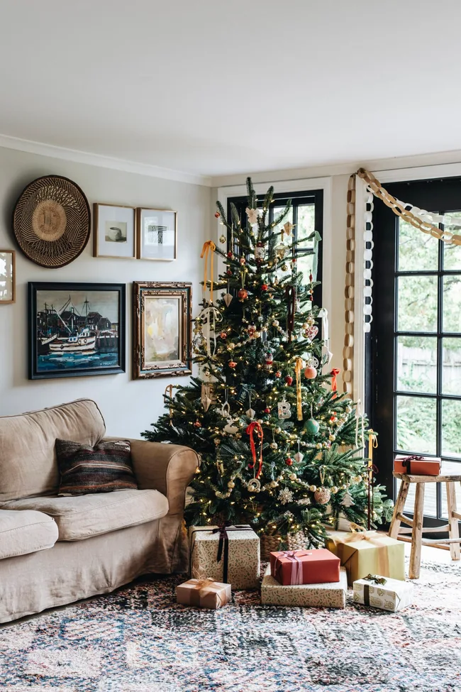 Twinkling lights mix with tarnished touches on this vintage inspired Christmas tree, alongside garlands