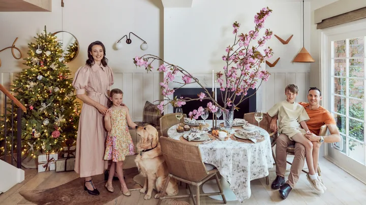 Kate Nixon with her family in front of her Christmas Tree