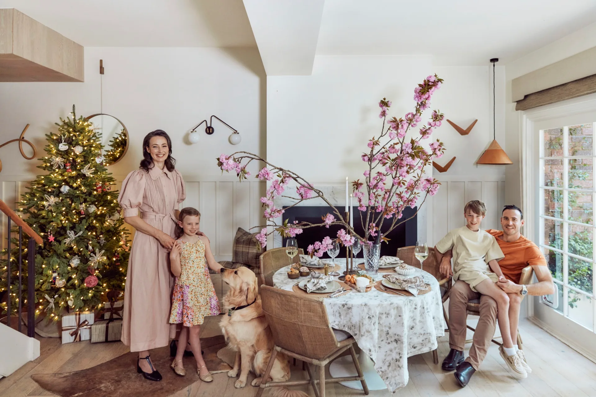 Kate Nixon with her family in front of her Christmas Tree 